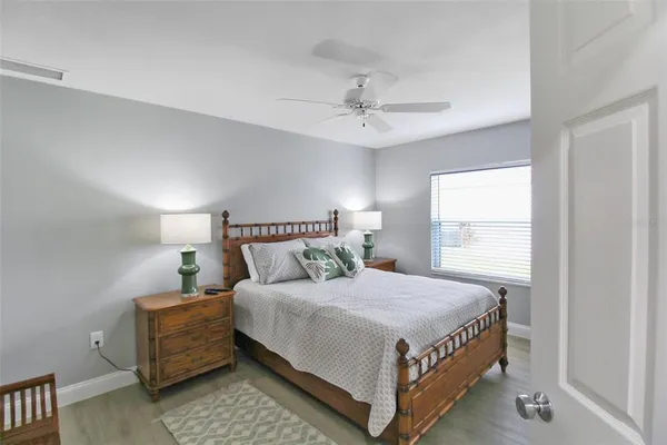 a bedroom with a bed and a painting on the wall
