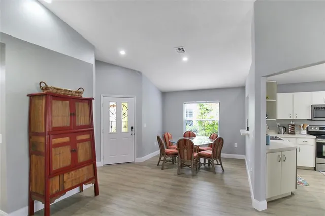 a view of a dining room with furniture and a window