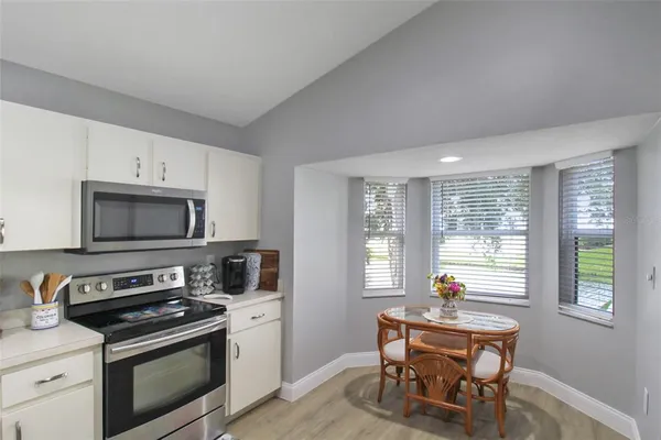 a kitchen with a stove a sink and a microwave