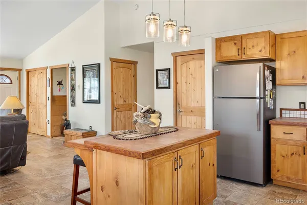 a kitchen with stainless steel appliances granite countertop a refrigerator a stove and a refrigerator