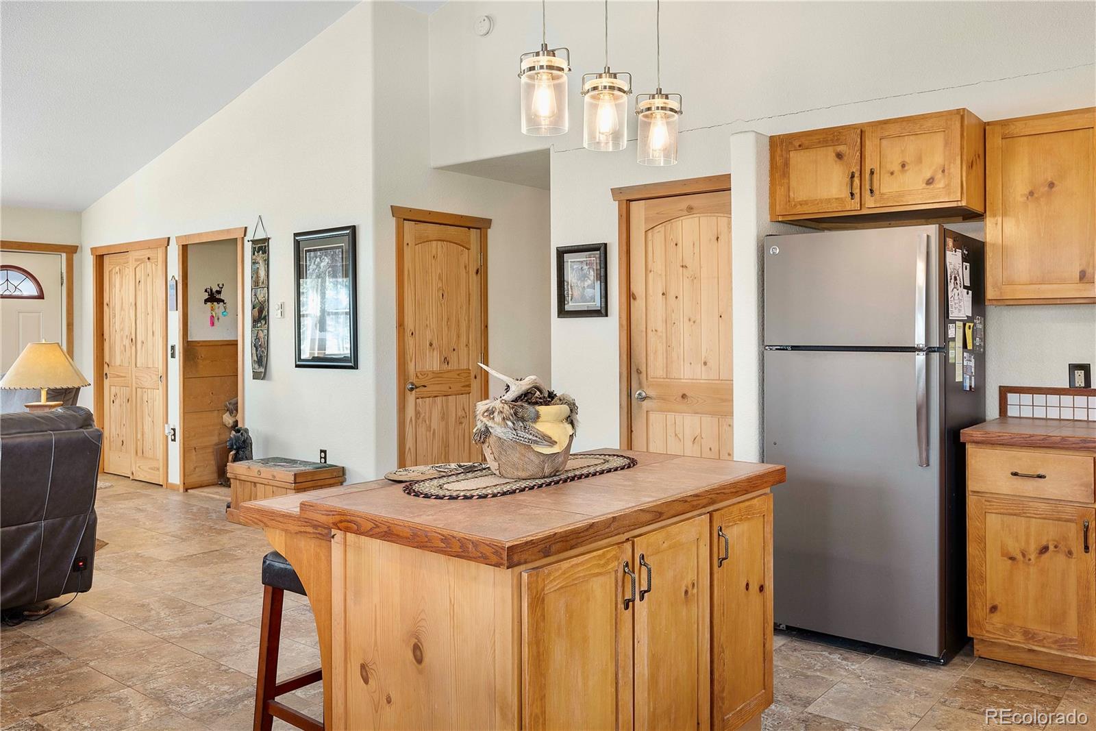 47 Piute Way Como, CO 80432 - Photo 12 of 50 a kitchen with stainless steel appliances granite countertop a refrigerator a stove and a refrigerator