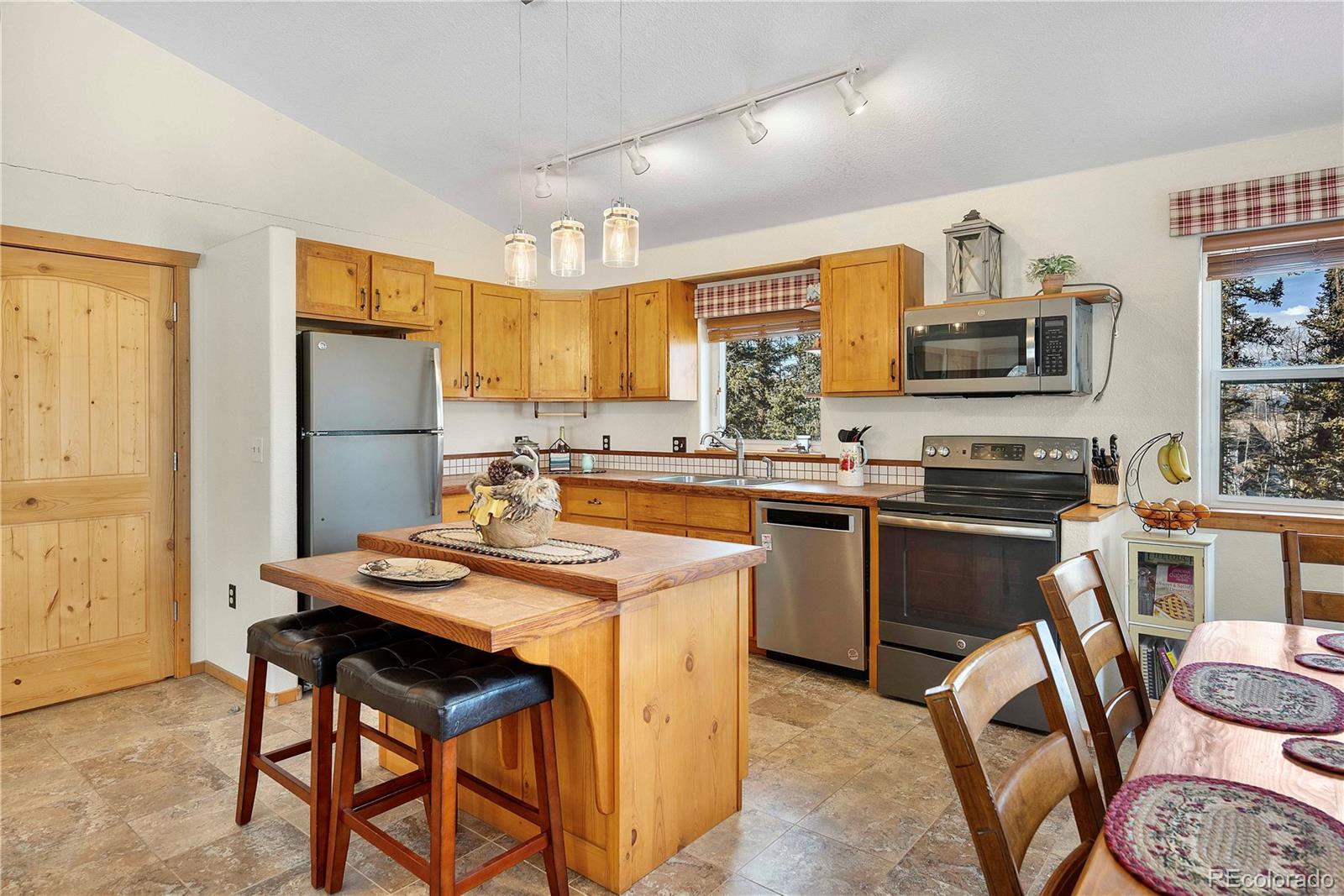47 Piute Way Como, CO 80432 - Photo 13 of 50 a kitchen with a sink stove and chairs