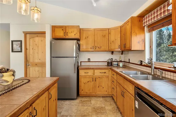 a kitchen with a refrigerator sink and stove