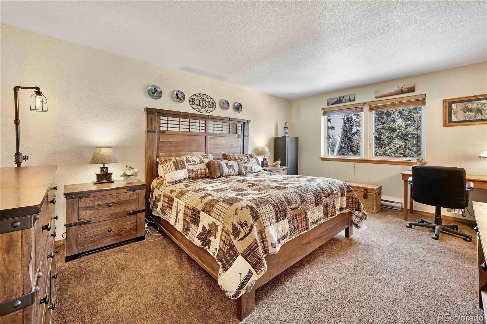47 Piute Way Como, CO 80432 - Photo 21 of 50 a spacious bedroom with a bed and chair