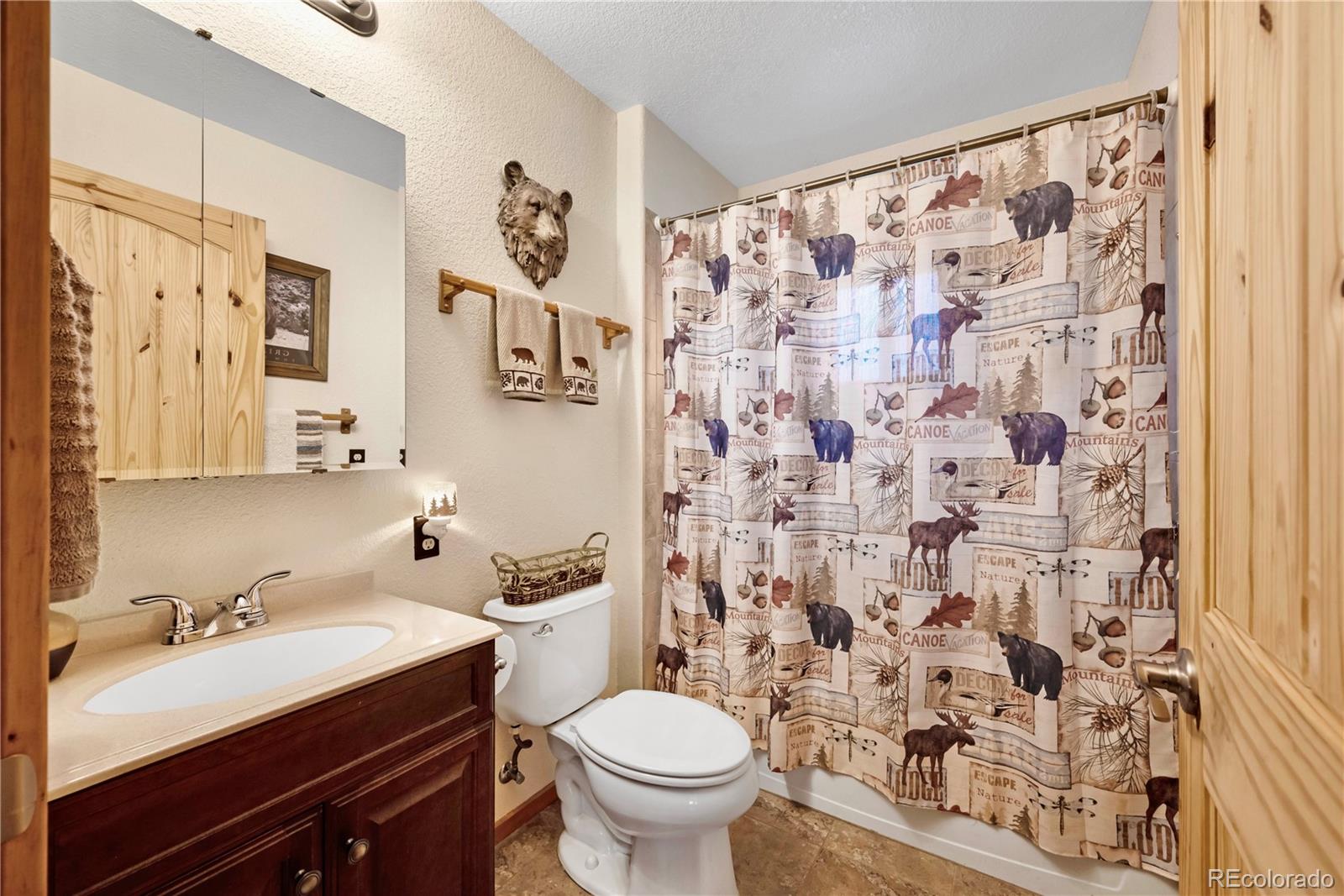 47 Piute Way Como, CO 80432 - Photo 32 of 50 a bathroom with a sink and a mirror