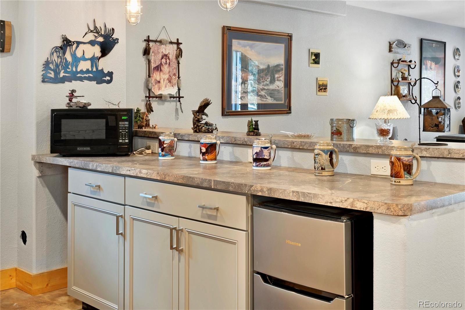 47 Piute Way Como, CO 80432 - Photo 38 of 50 a kitchen with stainless steel appliances granite countertop a sink and a wooden cabinets