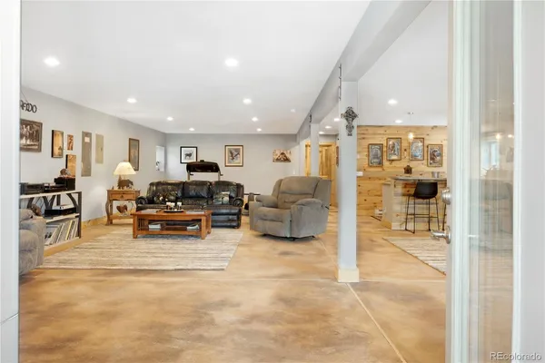 a view of kitchen with stainless steel appliances kitchen island granite countertop a refrigerator and cabinets