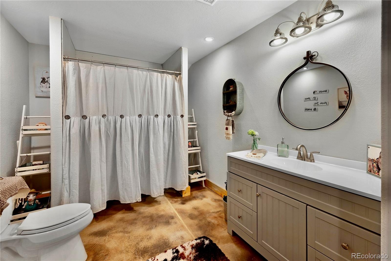 47 Piute Way Como, CO 80432 - Photo 44 of 50 a bathroom with a double vanity sink mirror and toilet