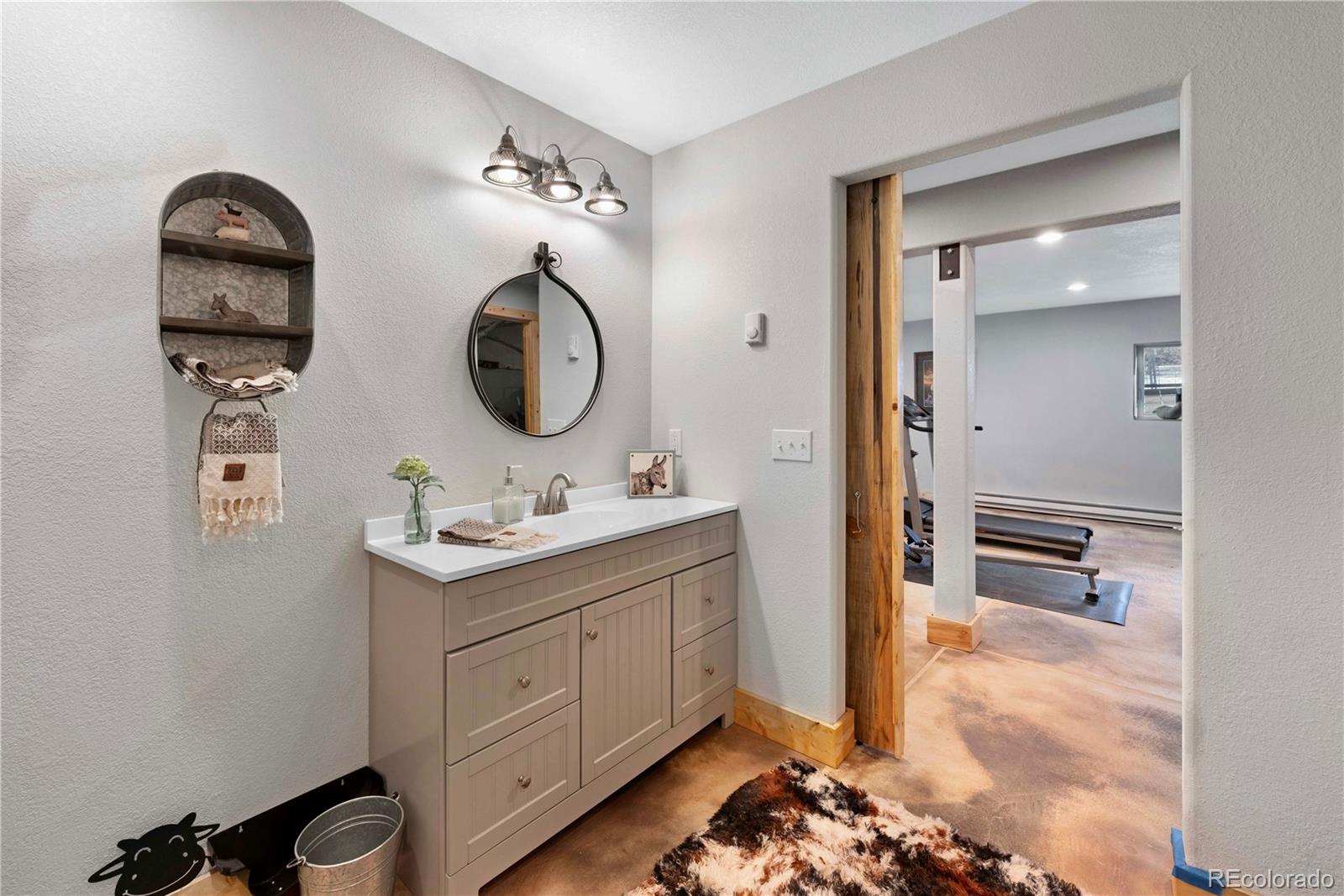 47 Piute Way Como, CO 80432 - Photo 45 of 50 a bathroom with a double vanity sink and a mirror