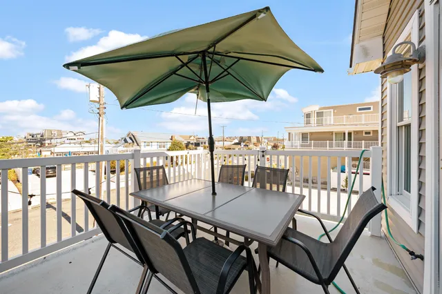 a view of a balcony with an outdoor seating