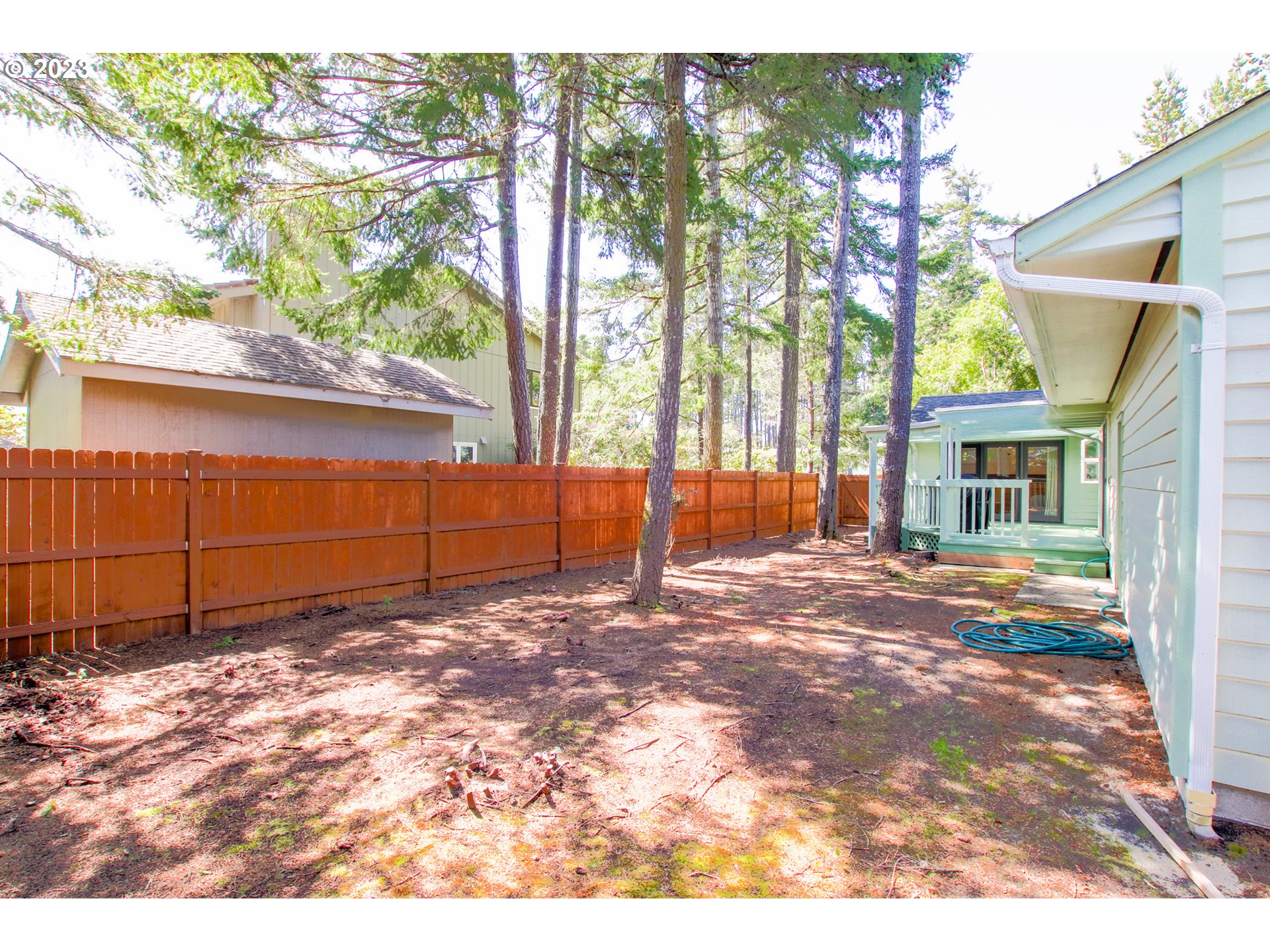 2240 23rd Street Florence, OR 97439 - Photo 11 of 37 a backyard of a house with a yard and outdoor seating