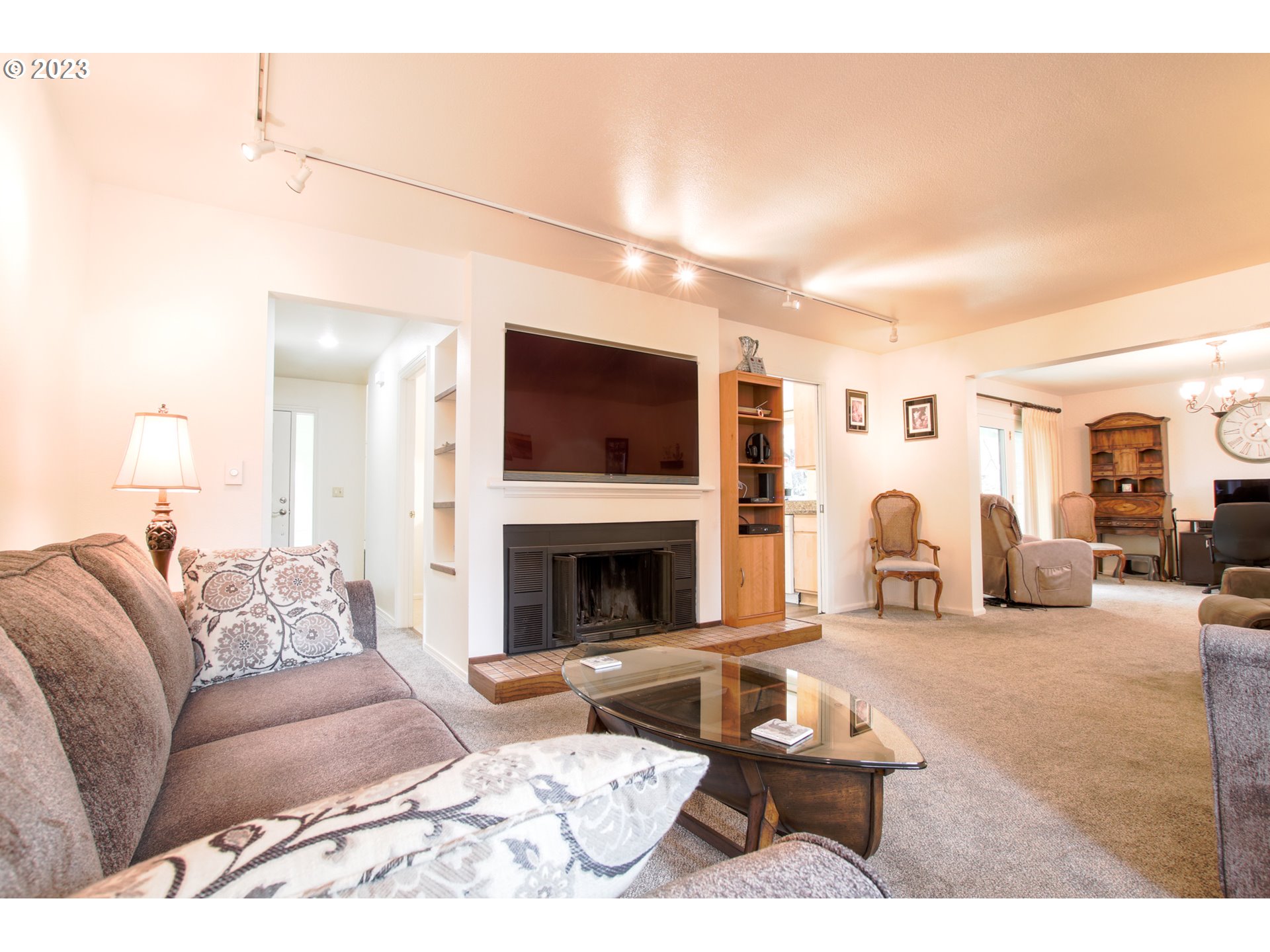 2240 23rd Street Florence, OR 97439 - Photo 14 of 37 a living room with furniture a fireplace and a flat screen tv