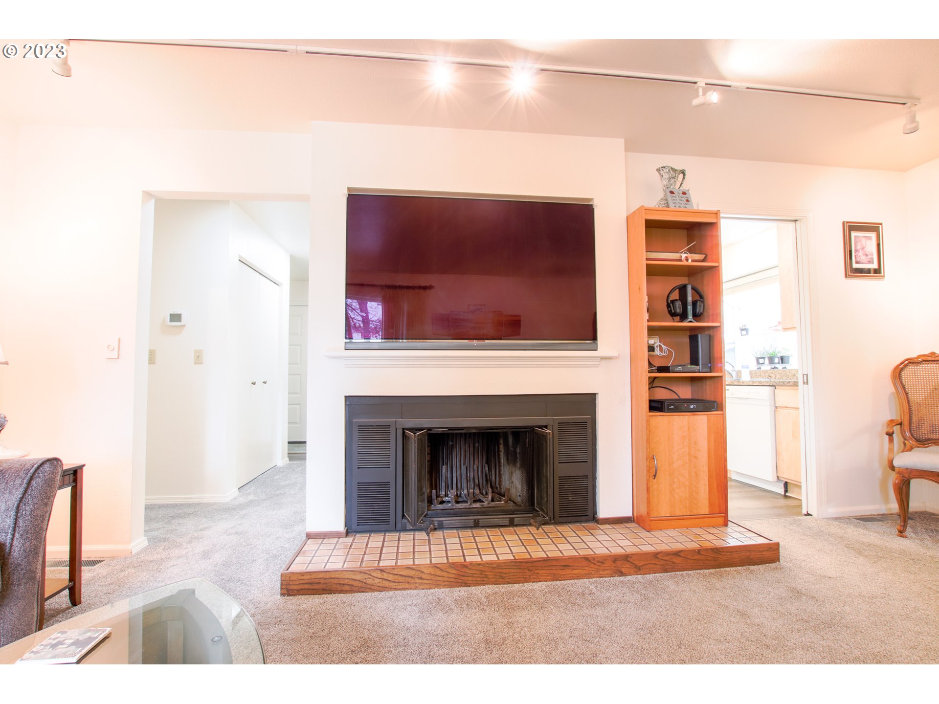 2240 23rd Street Florence, OR 97439 - Photo 15 of 37 a living room with a fireplace and a flat screen tv