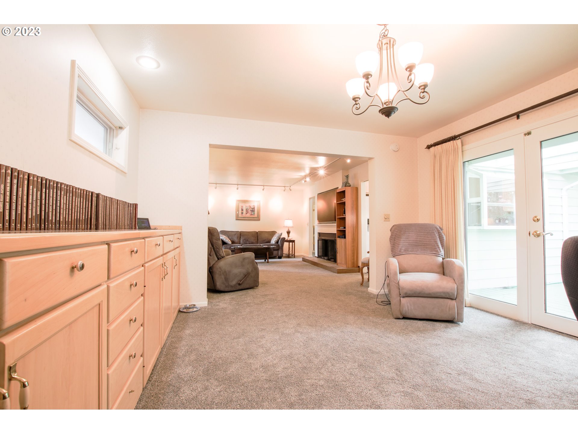 2240 23rd Street Florence, OR 97439 - Photo 16 of 37 a living room with furniture and a chandelier