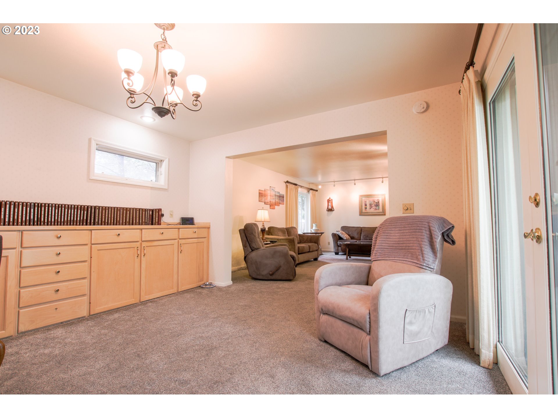 2240 23rd Street Florence, OR 97439 - Photo 17 of 37 a living room with furniture and a chandelier