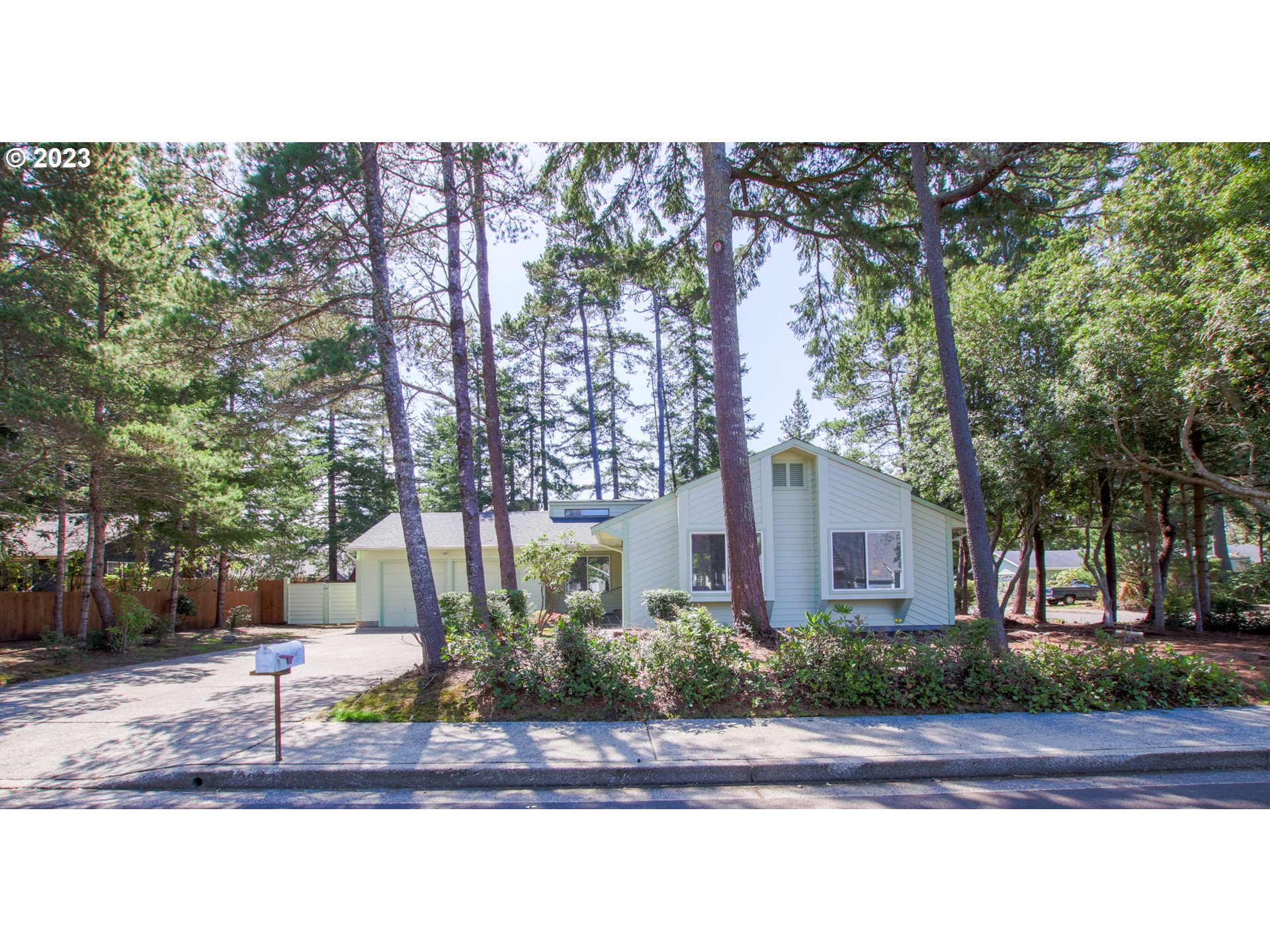 2240 23rd Street Florence, OR 97439 - Photo 2 of 37 a front view of a house with a yard and potted plants