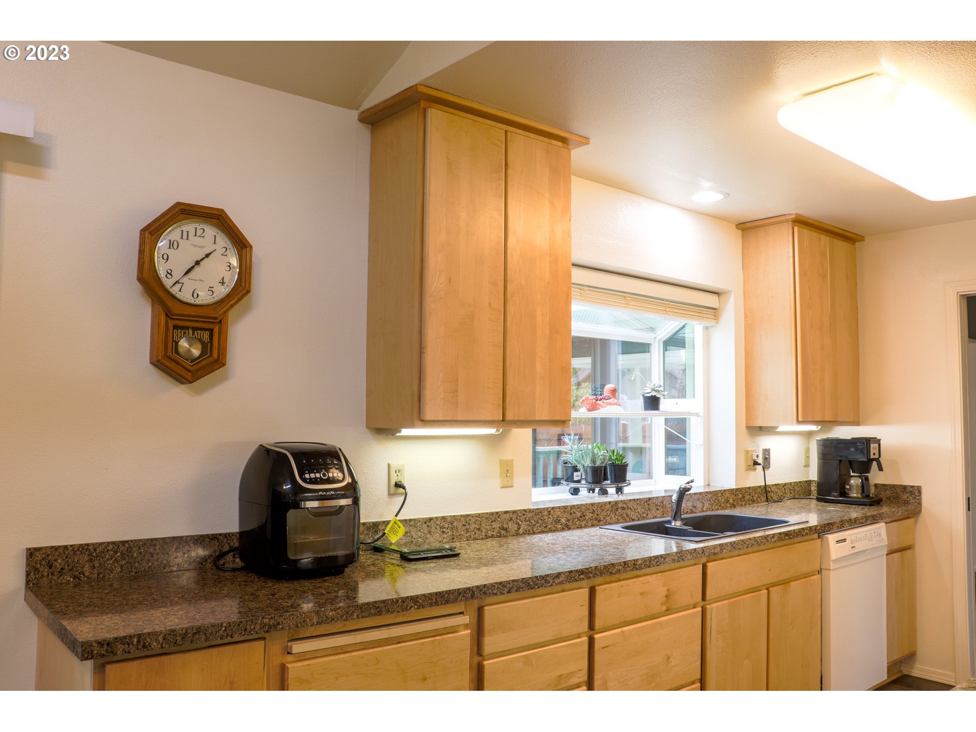 2240 23rd Street Florence, OR 97439 - Photo 23 of 37 a kitchen with a refrigerator and a sink