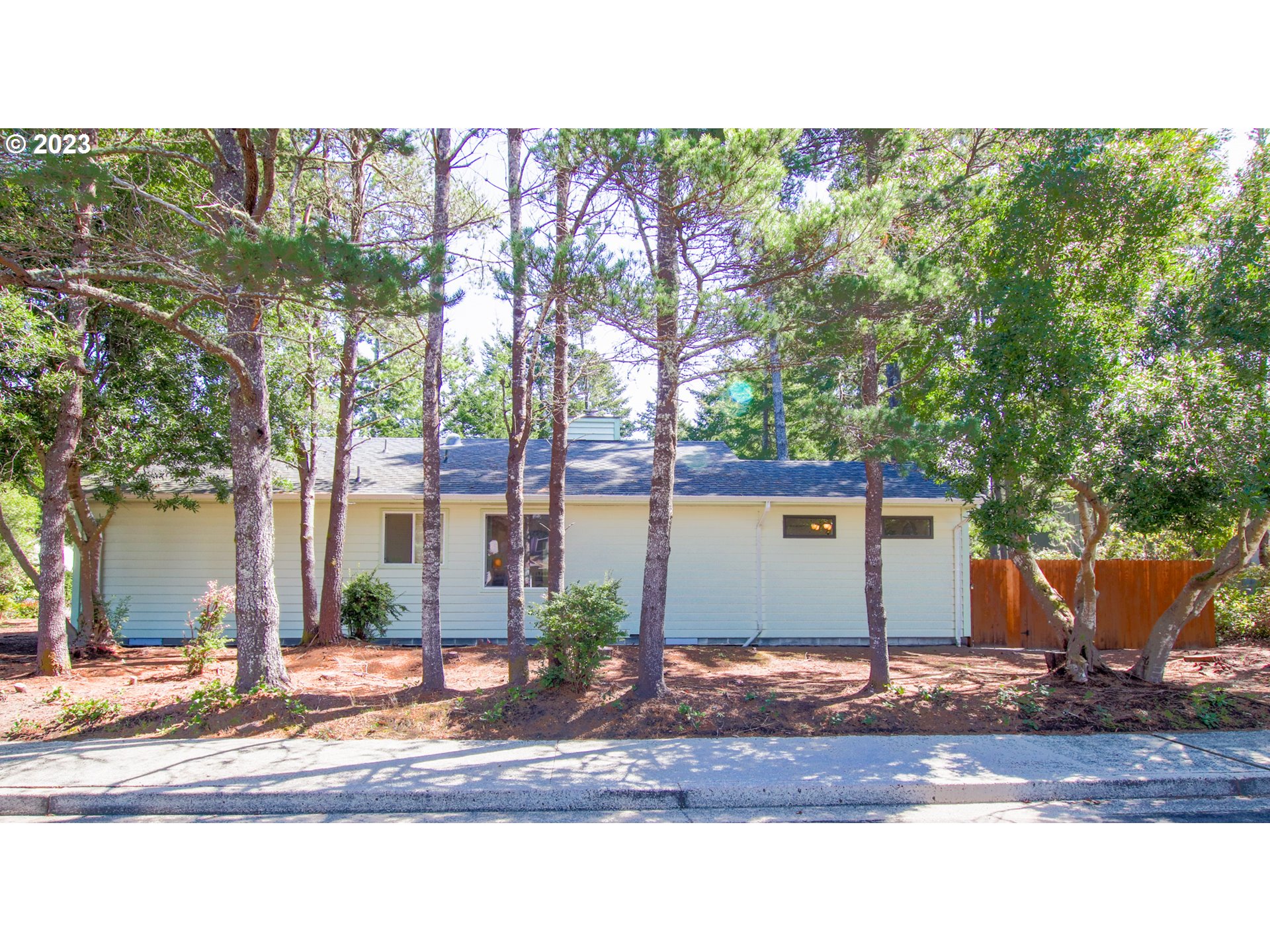 2240 23rd Street Florence, OR 97439 - Photo 3 of 37 a front view of a house with a yard and garage