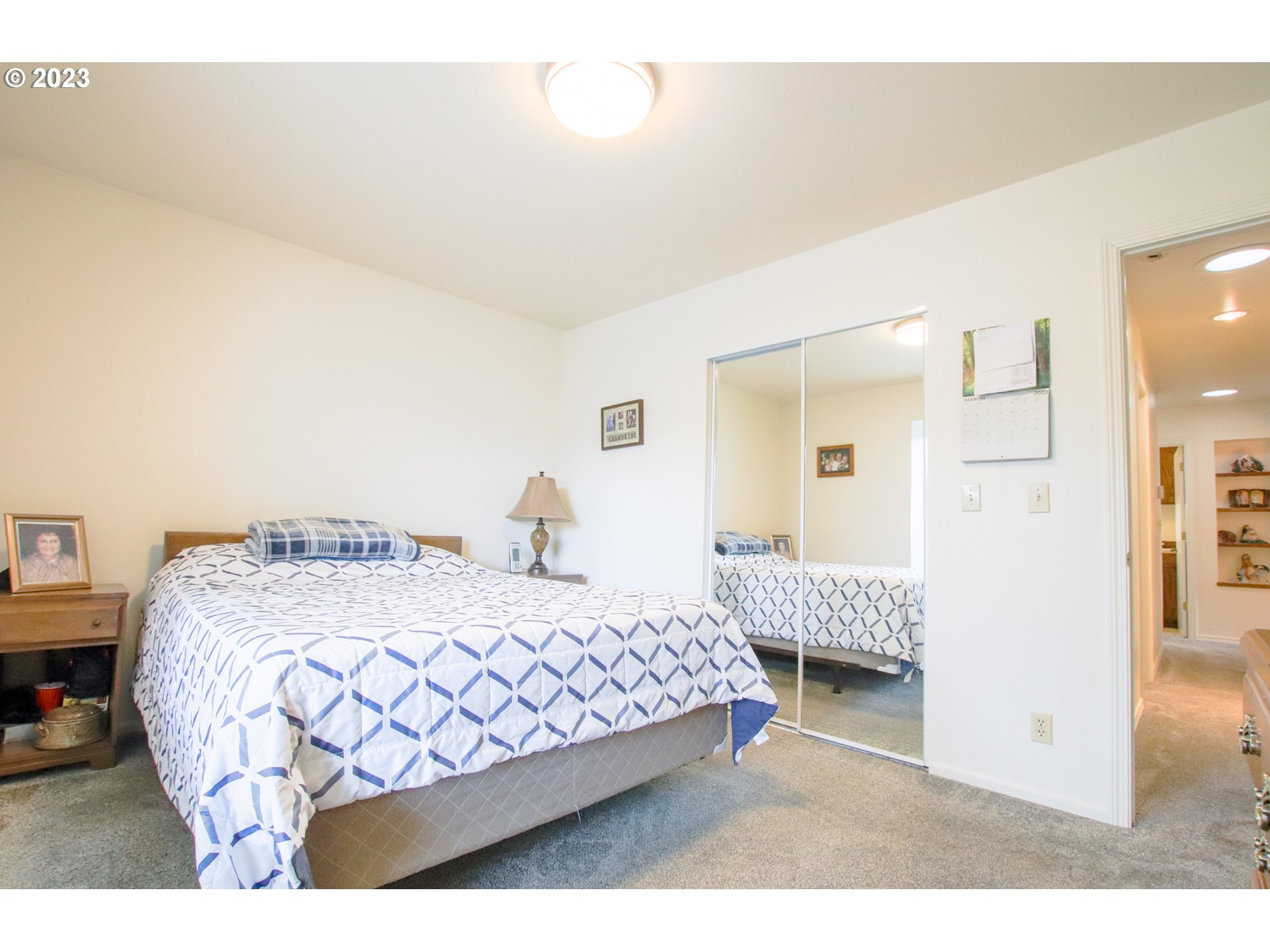 2240 23rd Street Florence, OR 97439 - Photo 33 of 37 a bedroom with a bed a mirror and desk