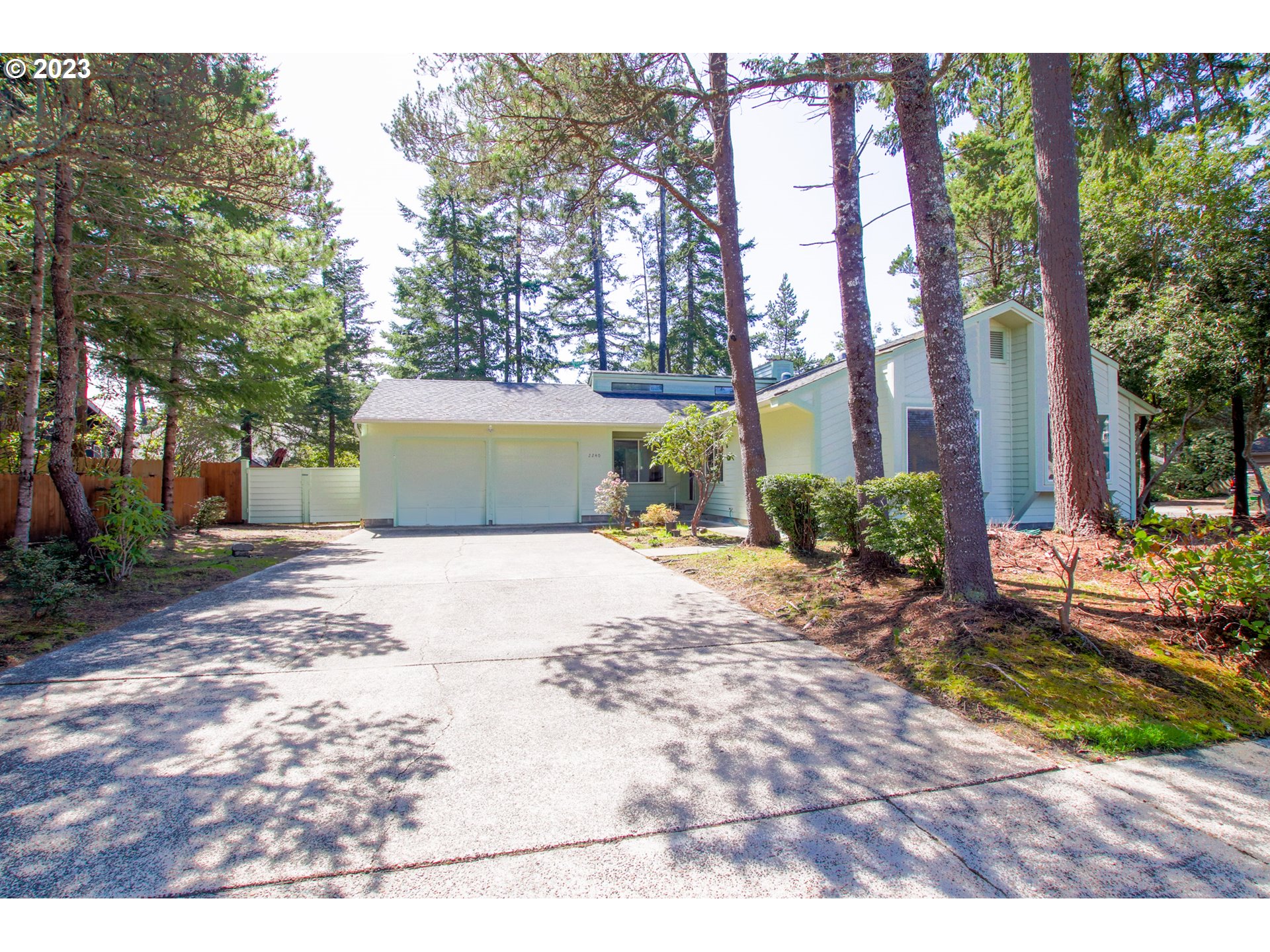 2240 23rd Street Florence, OR 97439 - Photo 4 of 37 a view of a yard with plants and trees