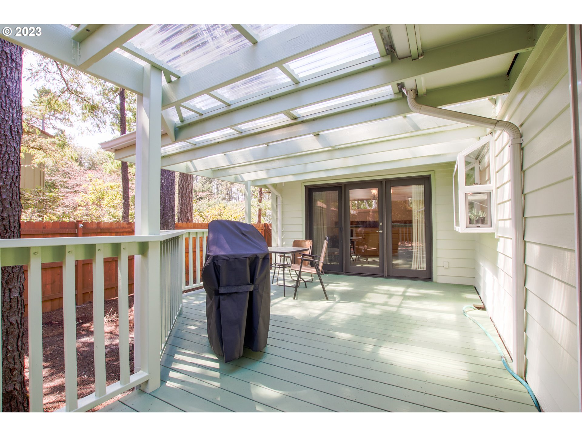 2240 23rd Street Florence, OR 97439 - Photo 8 of 37 a view of a porch with furniture and floor to ceiling window