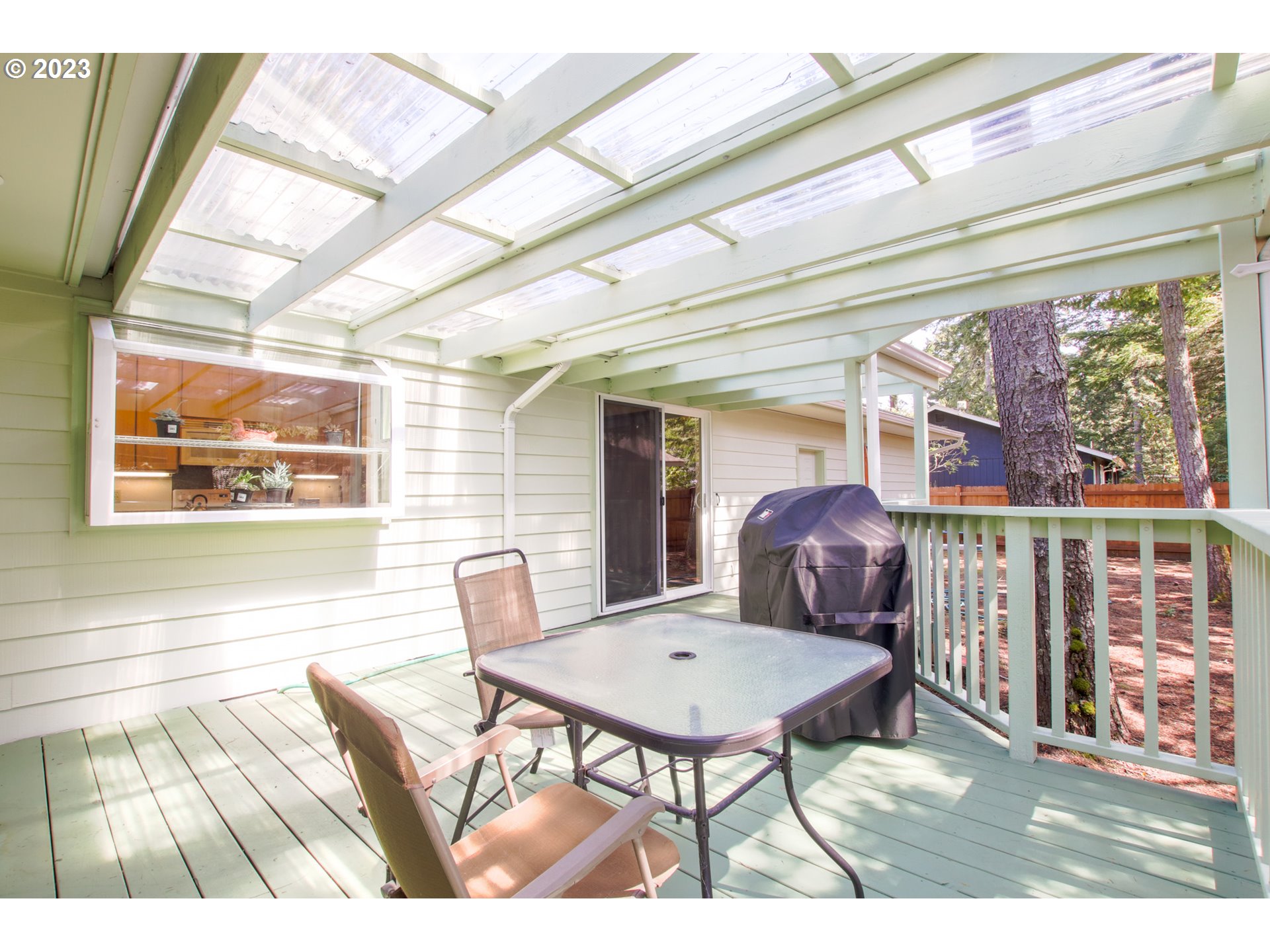 2240 23rd Street Florence, OR 97439 - Photo 9 of 37 a view of a dining room with furniture wooden floor and chandelier