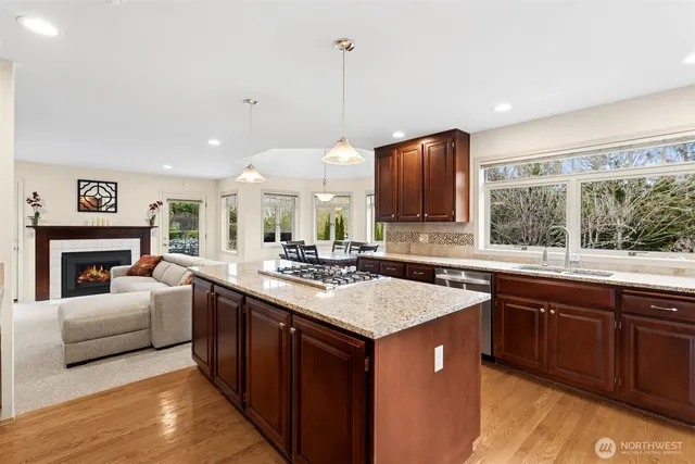 a kitchen with a stove sink and cabinets