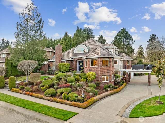 a view of a brick house with a wooden fence