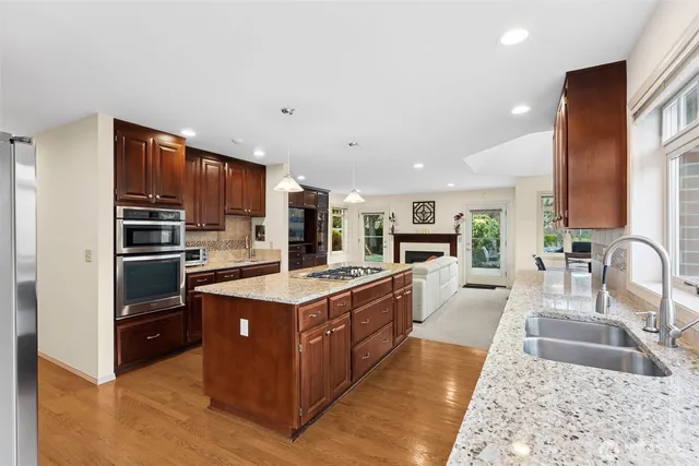 a kitchen with a sink stove and wooden cabinets