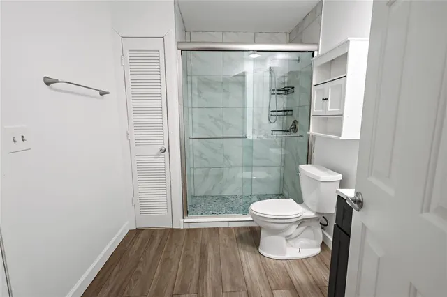 a bathroom with a toilet a sink a mirror and vanity