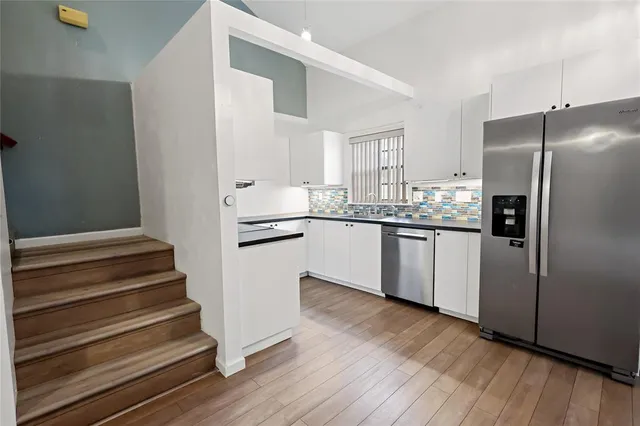 a view of a room with wooden floor and a window