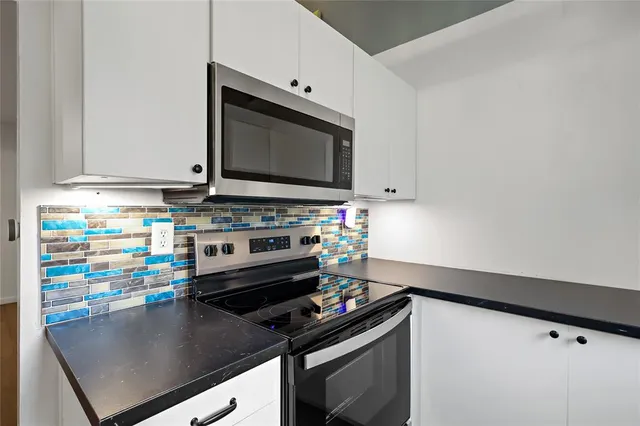 a kitchen with a stove and a microwave