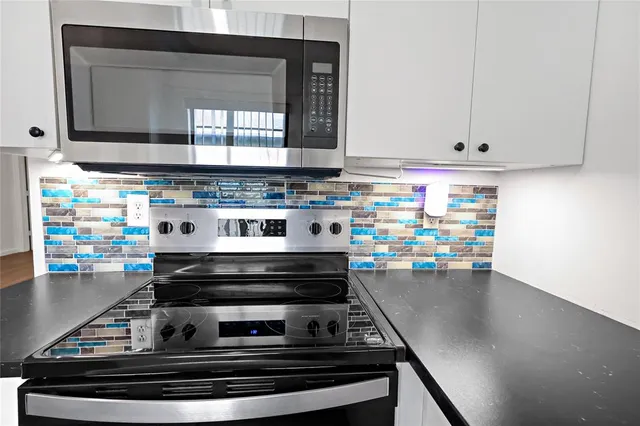 a view of a livingroom with wooden floor and a ceiling fan