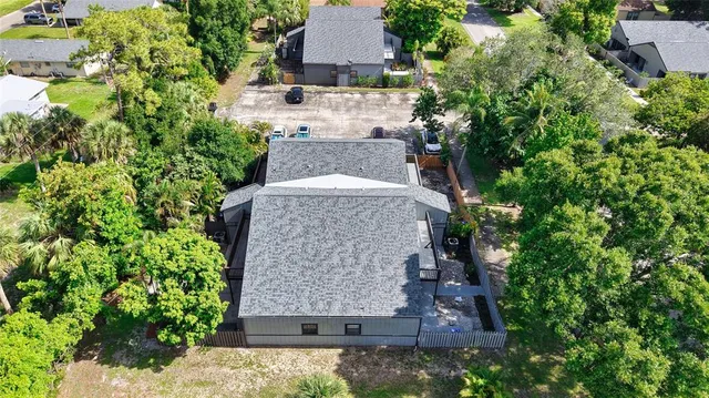 an aerial view of a house with a yard and garden