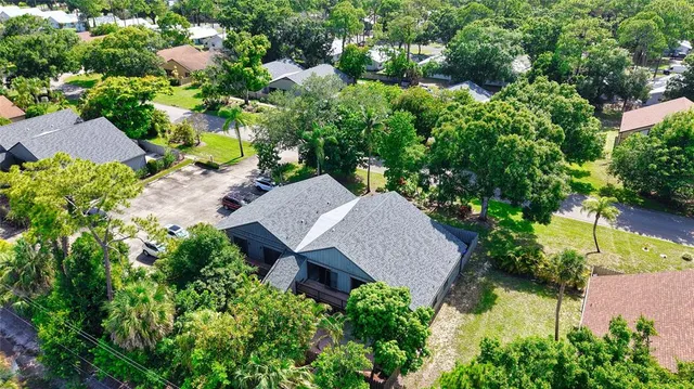 an aerial view of a house with a yard and garden