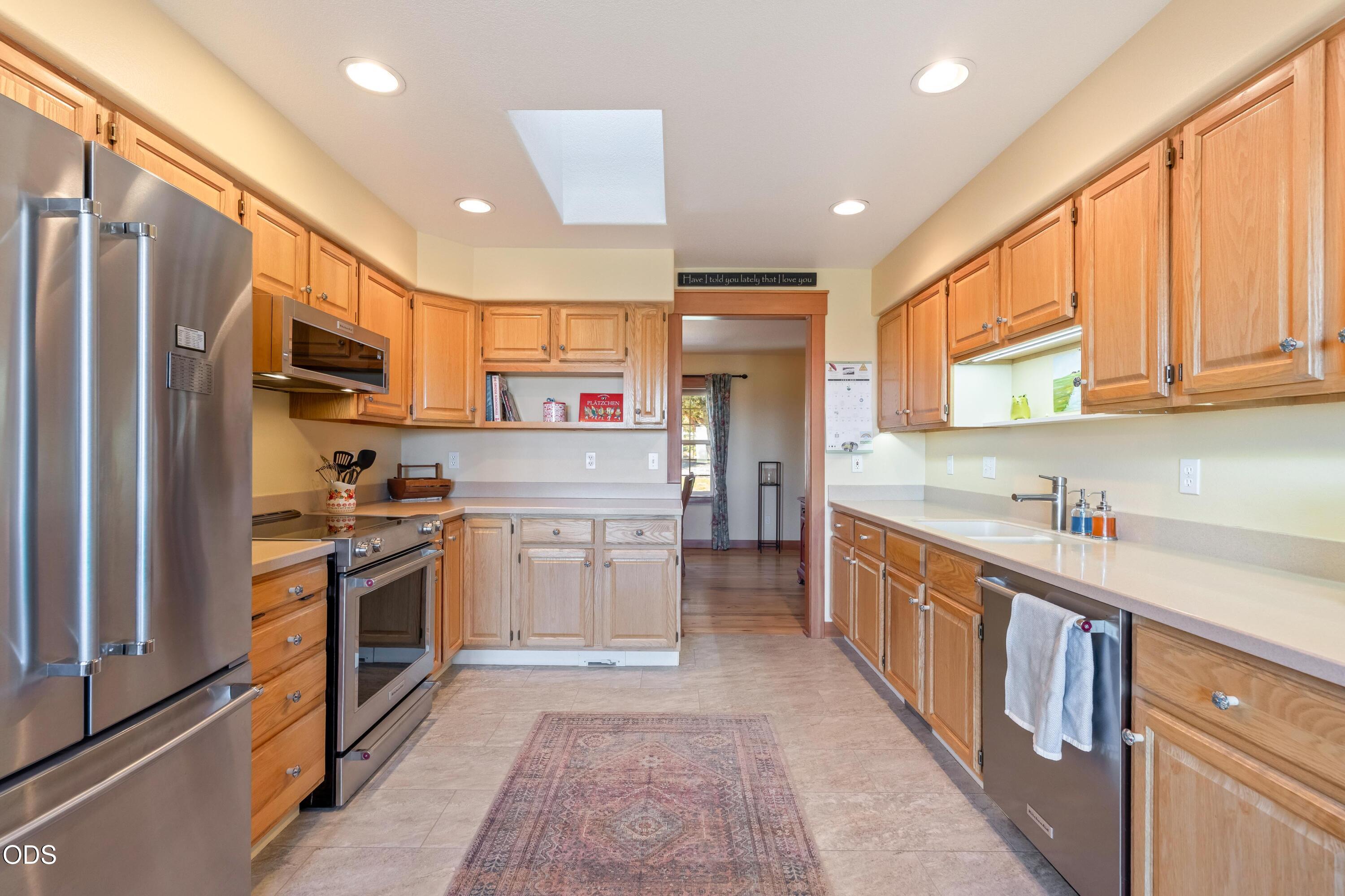 13753 South Sego Lily Road Powell Butte, OR 97753 - Photo 6 of 46 a kitchen with stainless steel appliances granite countertop a refrigerator a stove top oven a sink and dishwasher