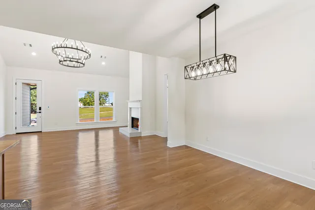 a large kitchen with kitchen island a large counter top space a sink stainless steel appliances and cabinets