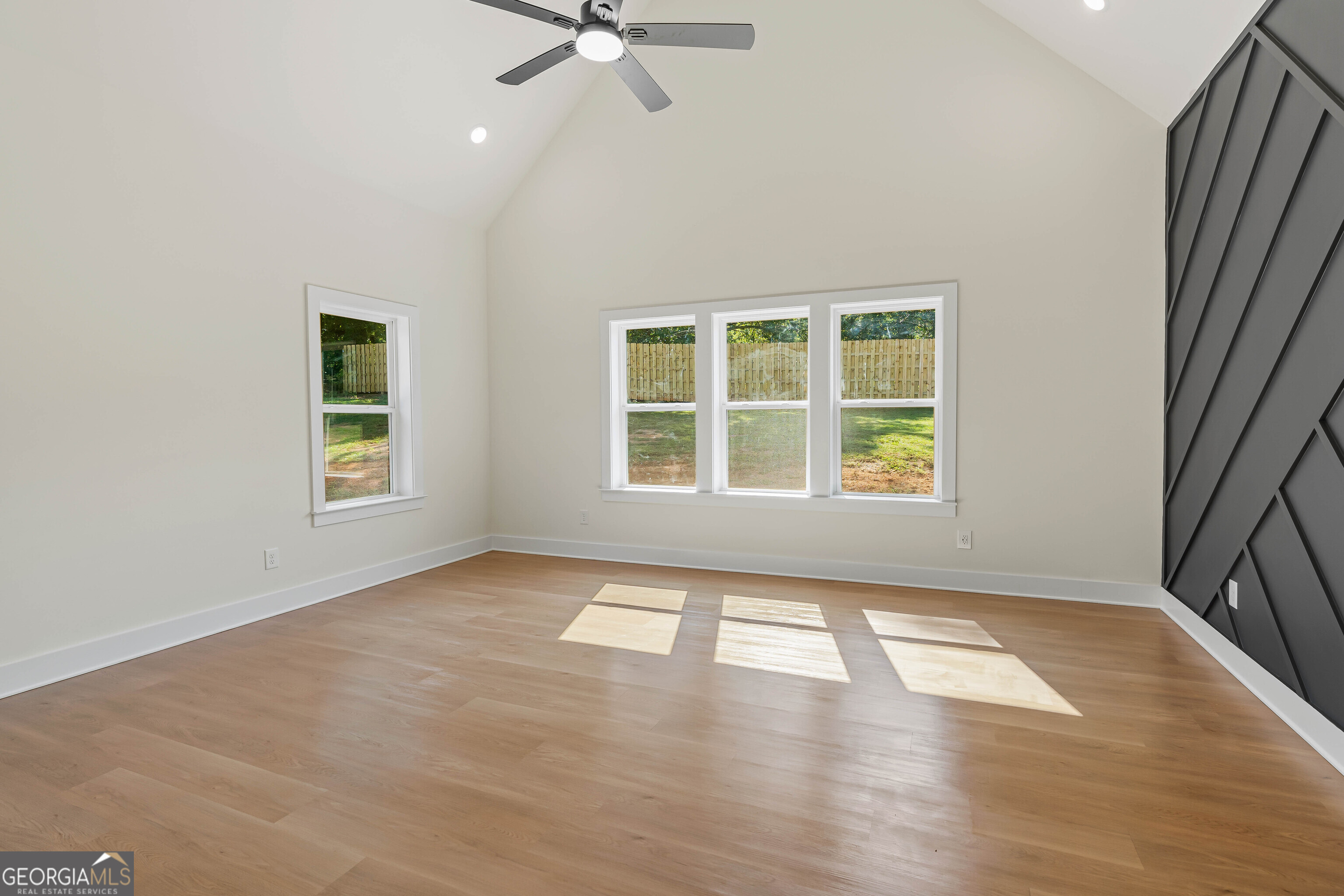 117 Oak Terrace Drive Clarkesville, GA 30523 - Photo 29 of 50 an empty room with wooden floor fan and windows