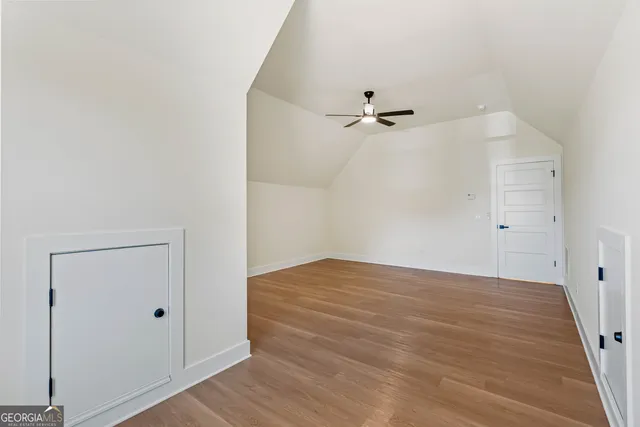 a bathroom with a granite countertop toilet and a sink