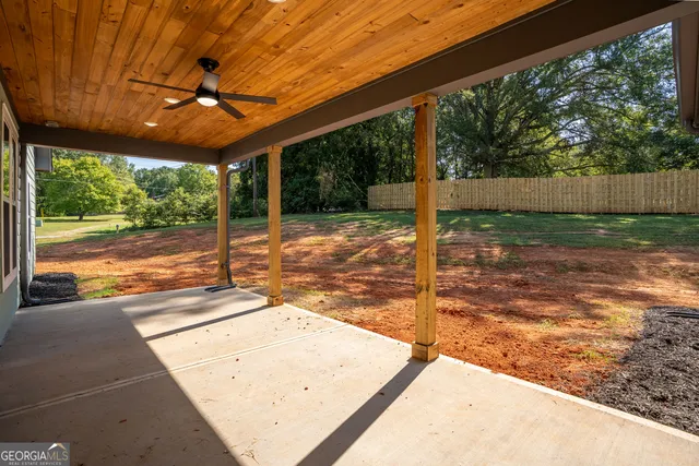 a view of a house with backyard and porch