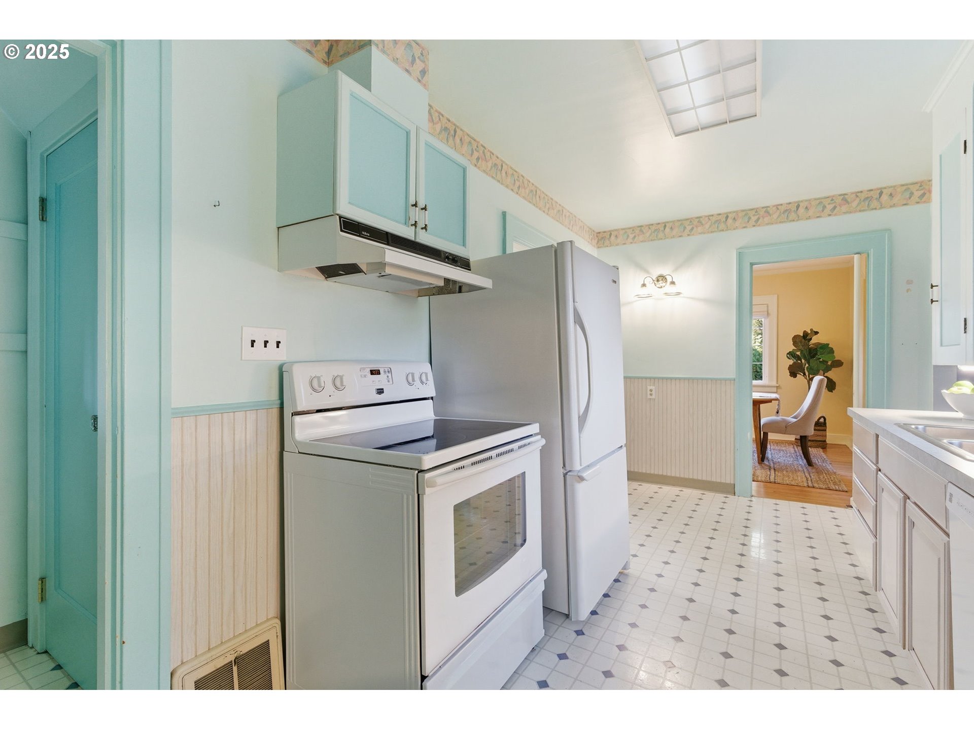8015 Southwest 45th Avenue Portland, OR 97219 - Photo 11 of 38 a kitchen with stainless steel appliances granite countertop a refrigerator and a sink