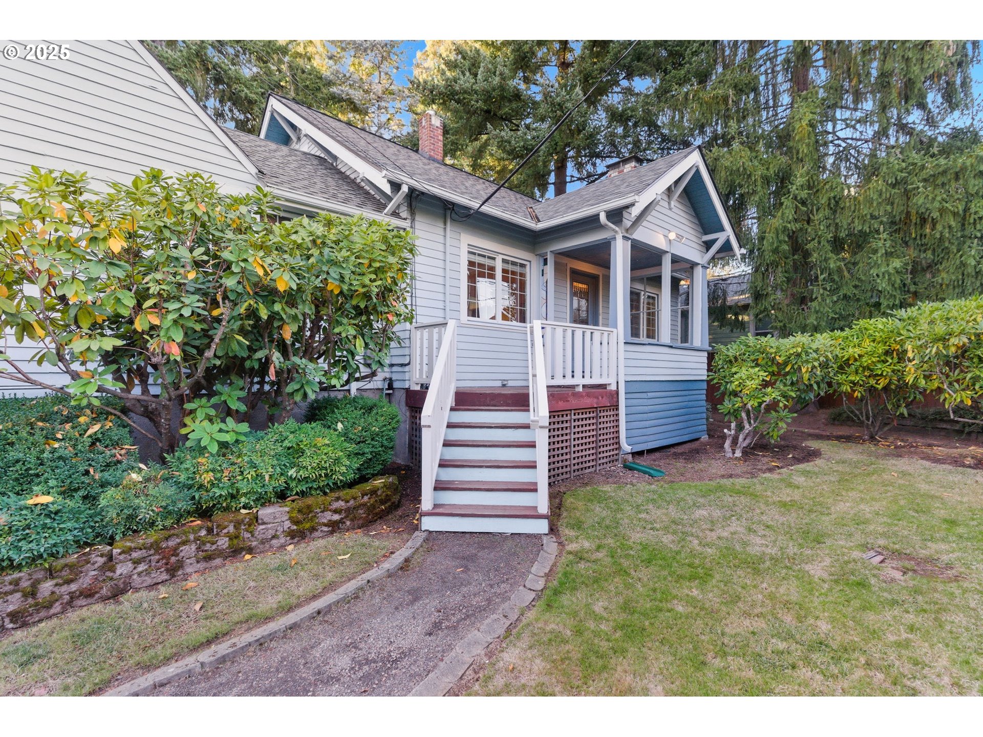 8015 Southwest 45th Avenue Portland, OR 97219 - Photo 2 of 38 a front view of a house with a yard