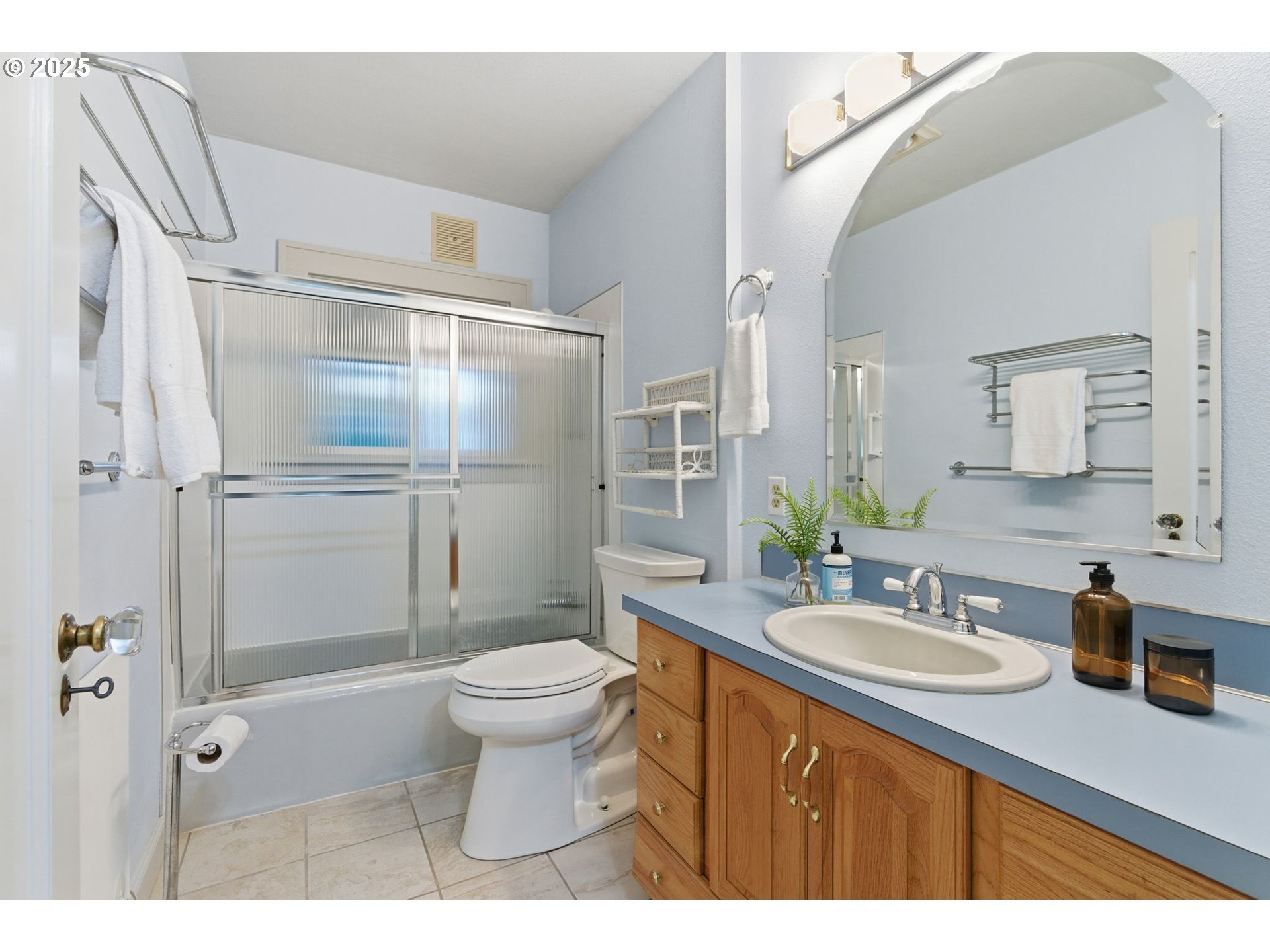 8015 Southwest 45th Avenue Portland, OR 97219 - Photo 21 of 38 a bathroom with a sink toilet double vanity and shower