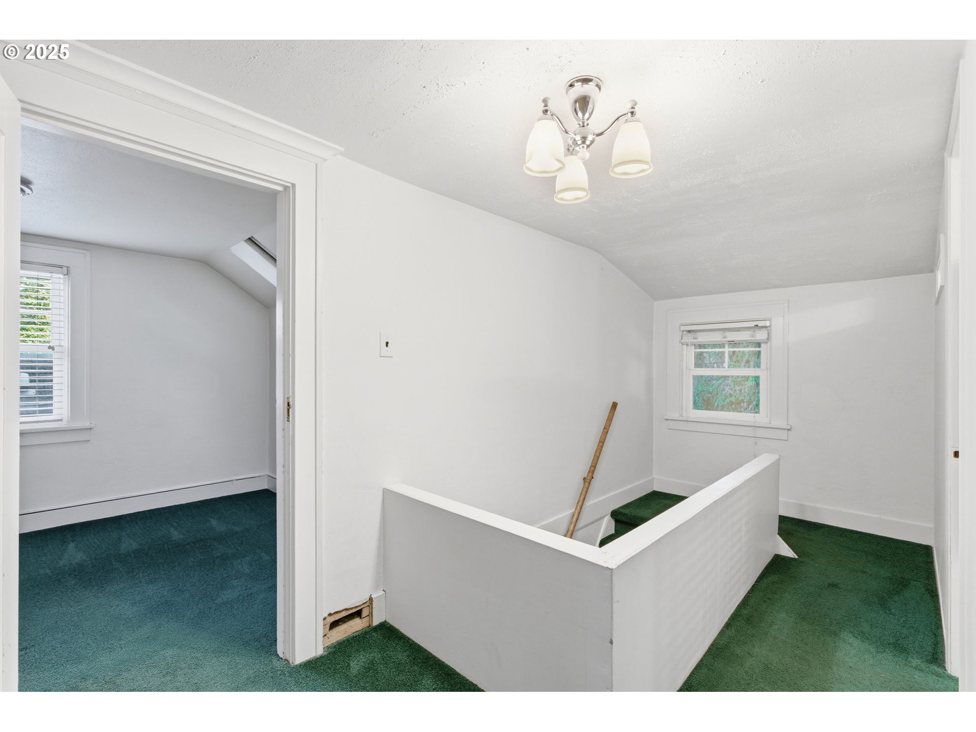 8015 Southwest 45th Avenue Portland, OR 97219 - Photo 23 of 38 a living room with a table and chairs