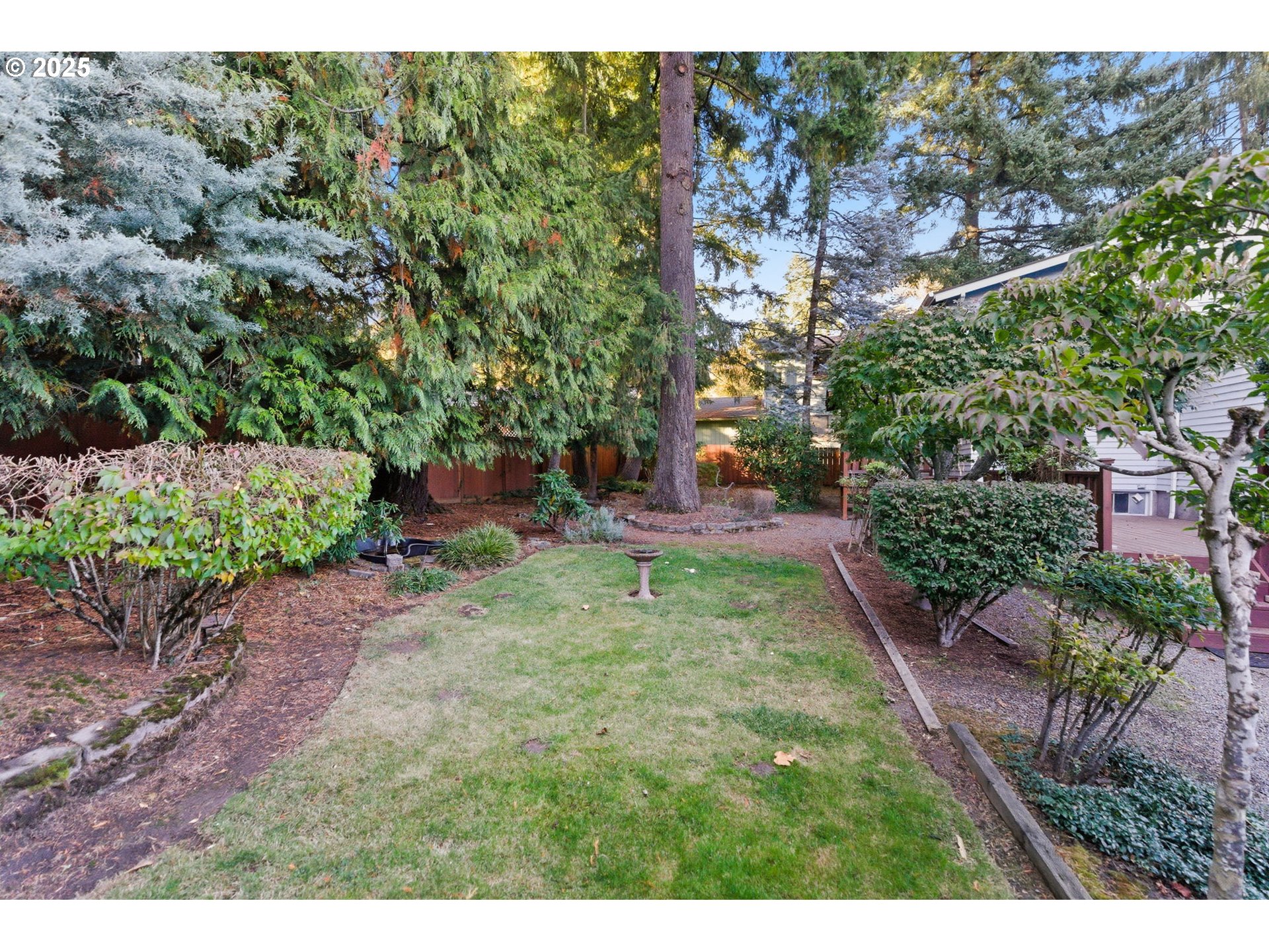 8015 Southwest 45th Avenue Portland, OR 97219 - Photo 35 of 38 a backyard of a house with lots of green space