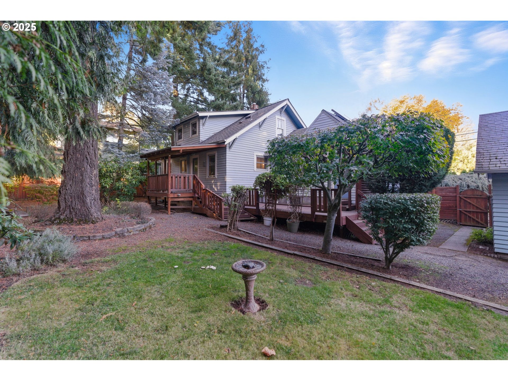 8015 Southwest 45th Avenue Portland, OR 97219 - Photo 36 of 38 a backyard of a house with table and chairs