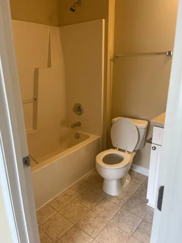 a bathroom with a toilet and a bathtub