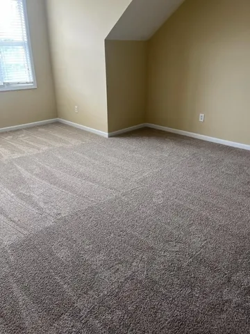 a view of an empty room and a window