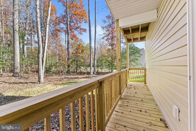 a view of balcony with wooden floor and fence