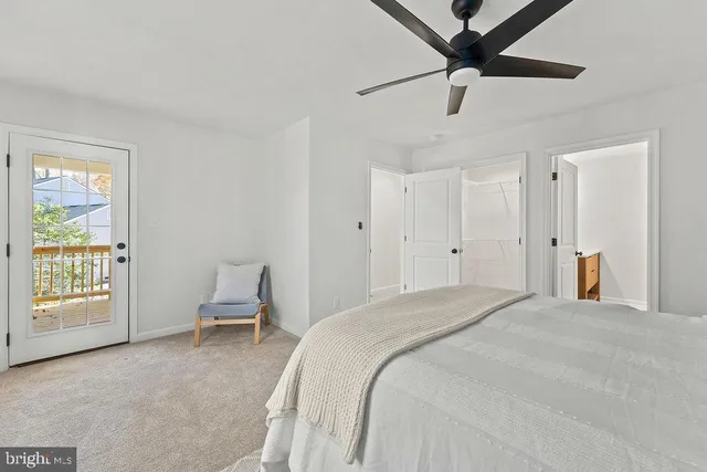 a spacious bedroom with a bed and a window